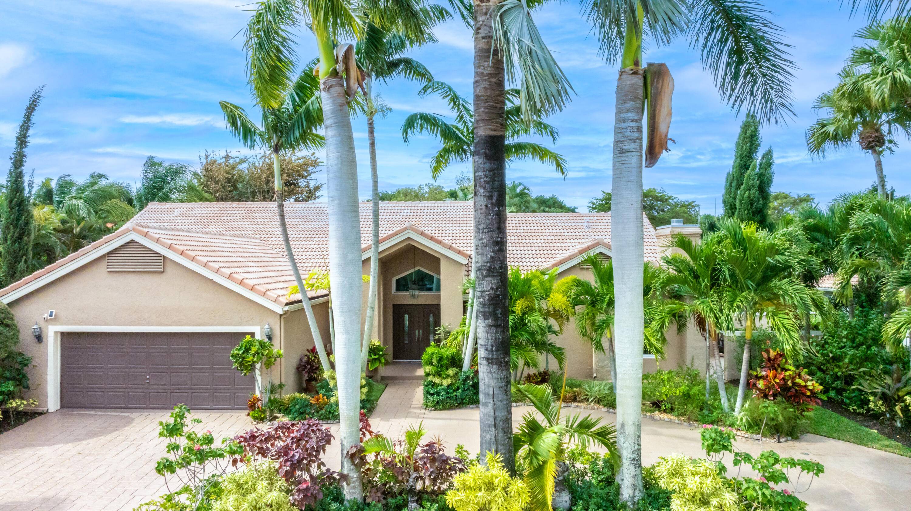 Stunning and serene single level pool home in the exclusive New Floresta in central Boca.