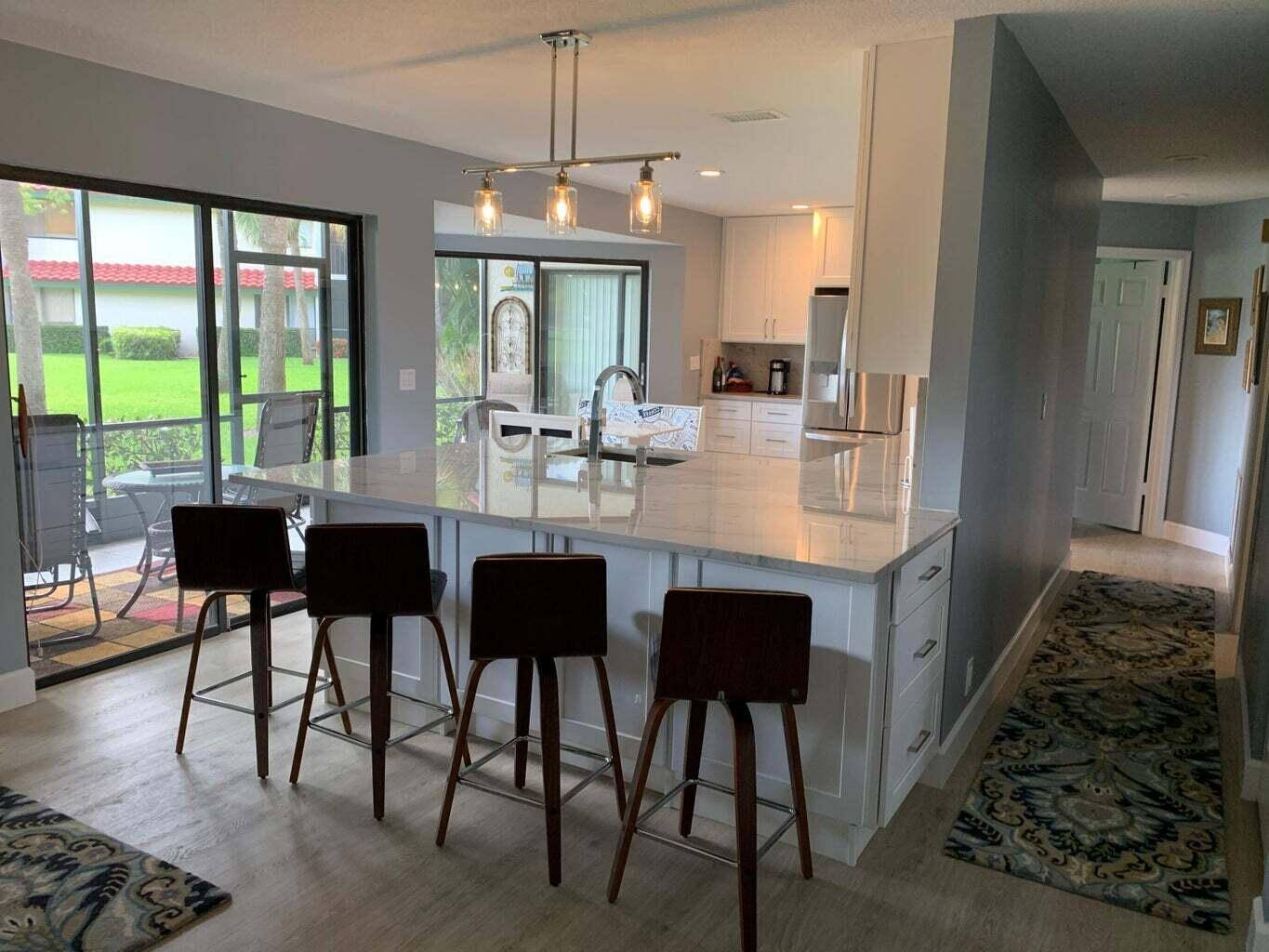 Beautiful 2 bedroom 2 bath 1 car garage condo with screened patio overlooking lake in PGA National.