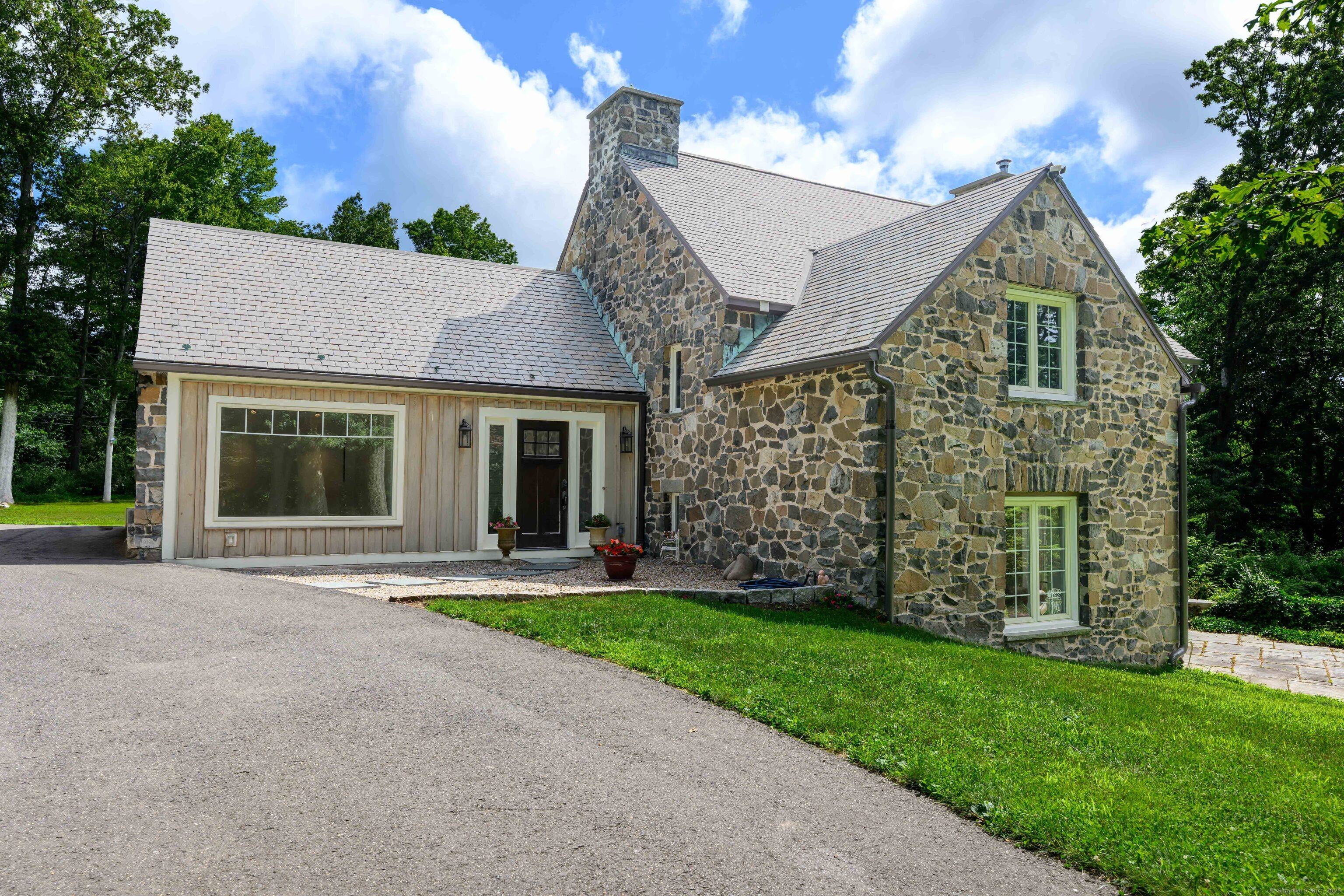 Nestled in a serene and sought after Bethany Woods neighborhood, this stately stone home exudes both timeless charm and casual elegance.