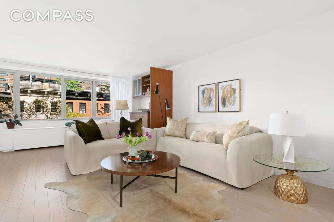 With a wall of five contiguous windows, this oversized alcove studio feels like a one bedroom.
