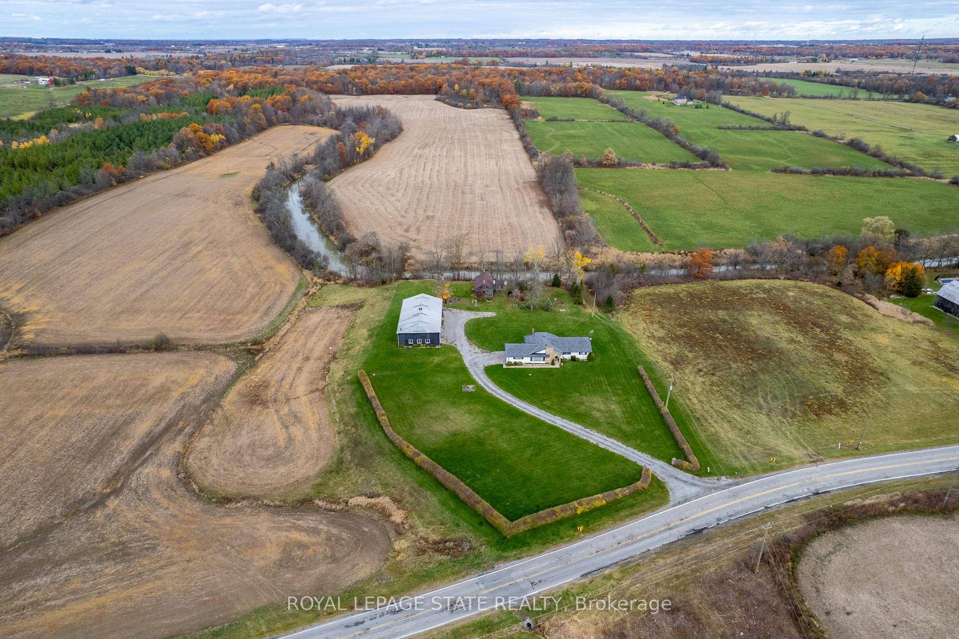 Exceptional 78 acre property, showcasing rolling farmland, creek, and forested area with sugar maples at the back of the property.