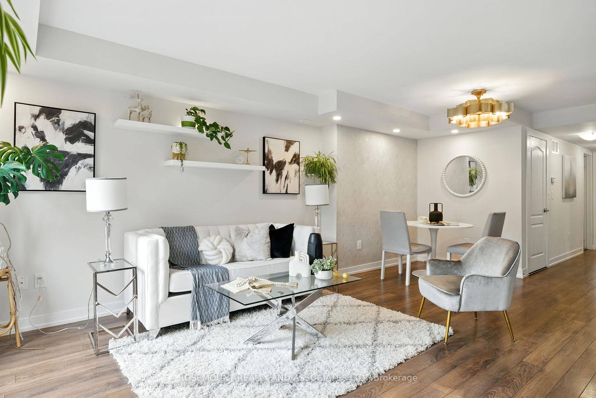 Welcome to this rare, south facing, private entrance end unit at The Brownstones in Grand Cornell.