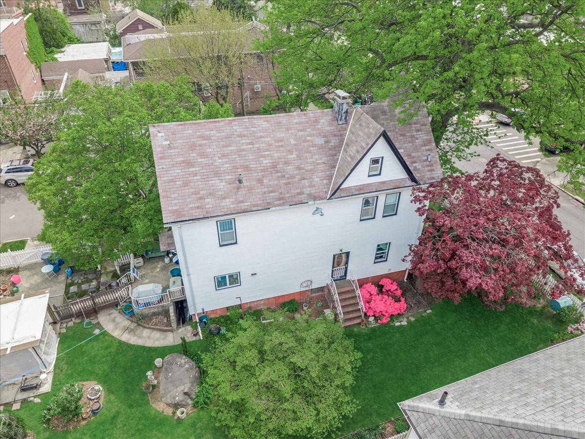 Step into timeless elegance with this classic 1920 three story Colonial, set on a spacious 50x100 corner lot in the desirable North side of College Point.