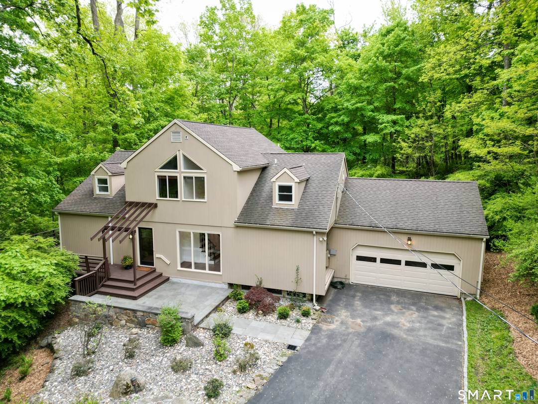 This iconic mid century modern home offers a rare blend of architectural character and natural beauty, situated on two private acres along Olmstead Hill one of Wilton's designated scenic roads.