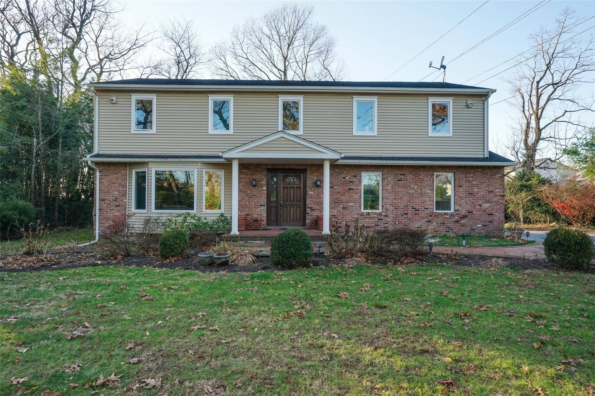 Spacious Colonial set back on a private one acre in the Village of Roslyn Harbor adjacent to the exclusive Engineers Country Club with unobstructed golf course views.