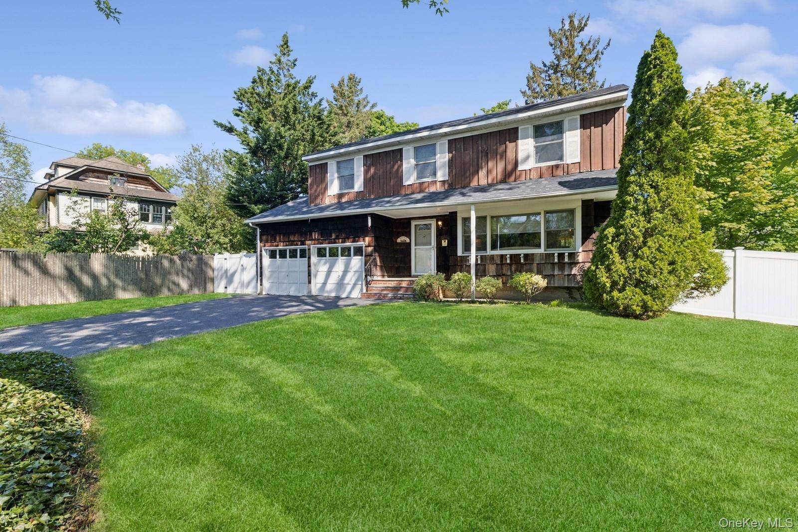 Welcome to 126 Carley Avenue, a captivating Colonial residence nestled in the heart of Huntington, NY.