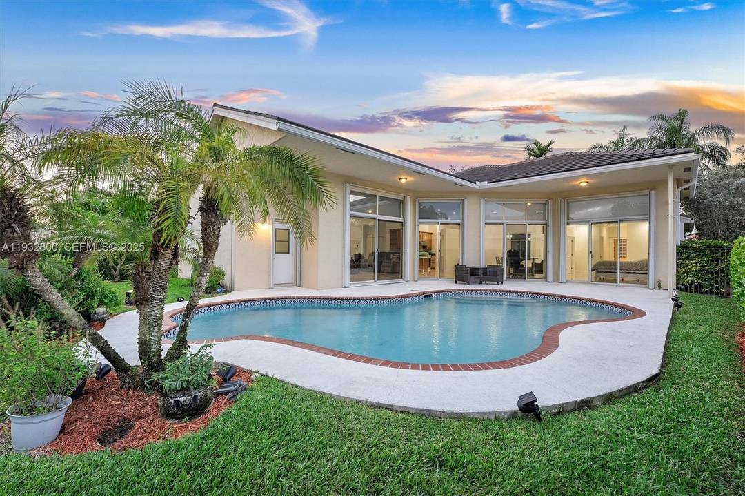 This beautifully maintained residence offers elegant one level living in the prestigious gated community of Weston Hills.