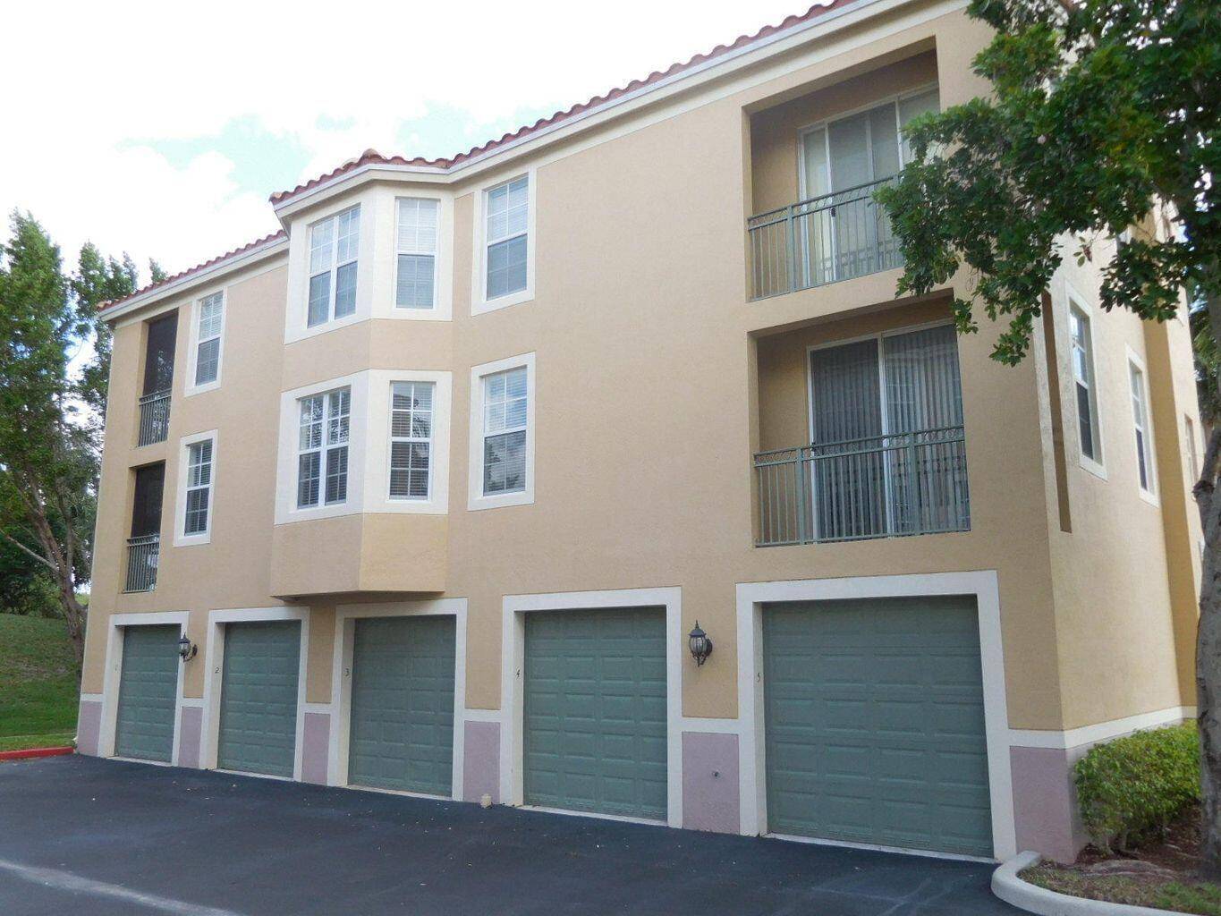 SPACIOUS 3 BED, 2 BATH CONDO WITH NEW FLOORING, FRESH PAINT, AND NEWLY INSTALLED IMPACT WINDOWS !