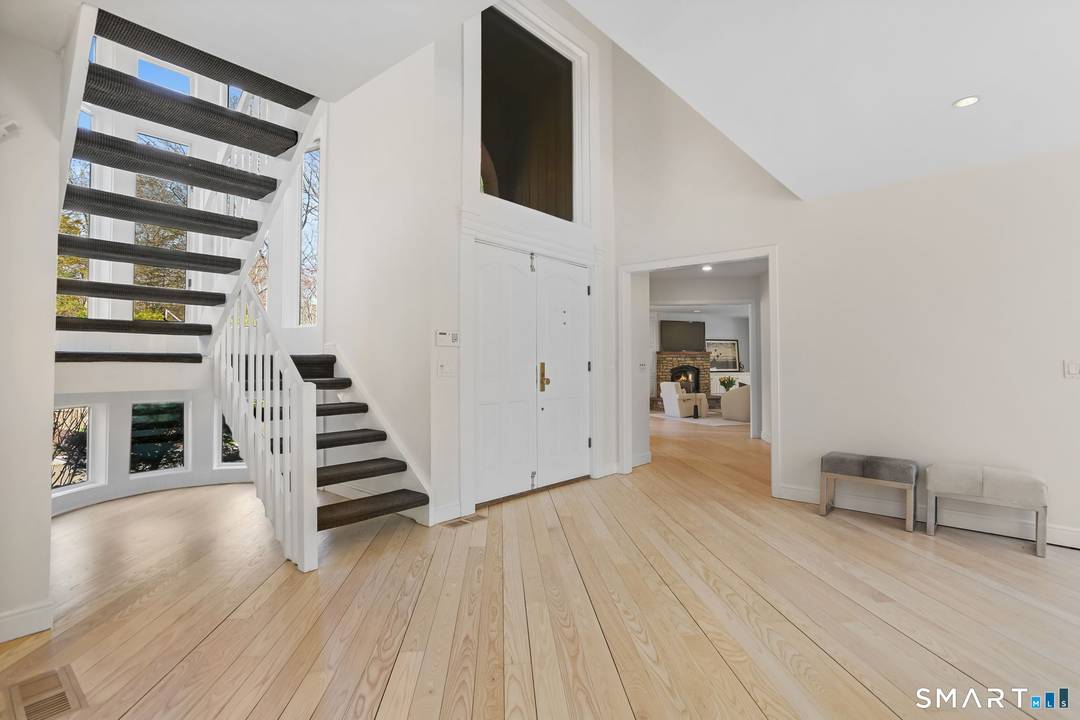 Set along the Saugatuck River on a quiet lower Weston cul de sac, this architecturally distinctive contemporary is privately sited on 2.