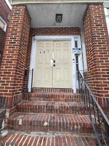 Turnkey fully detached BRICK two family home with multiple parking in Newark ?
