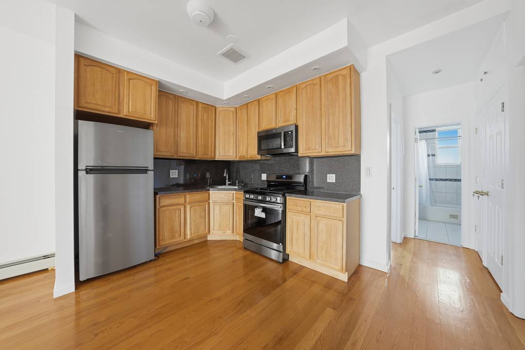 Move right into this lovely renovated two family townhouse featuring flexible living space, a finished basement and future expansion potential.