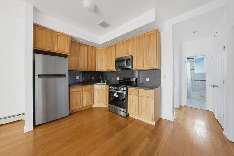 Move right into this lovely renovated two family townhouse featuring flexible living space, a finished basement and future expansion potential.
