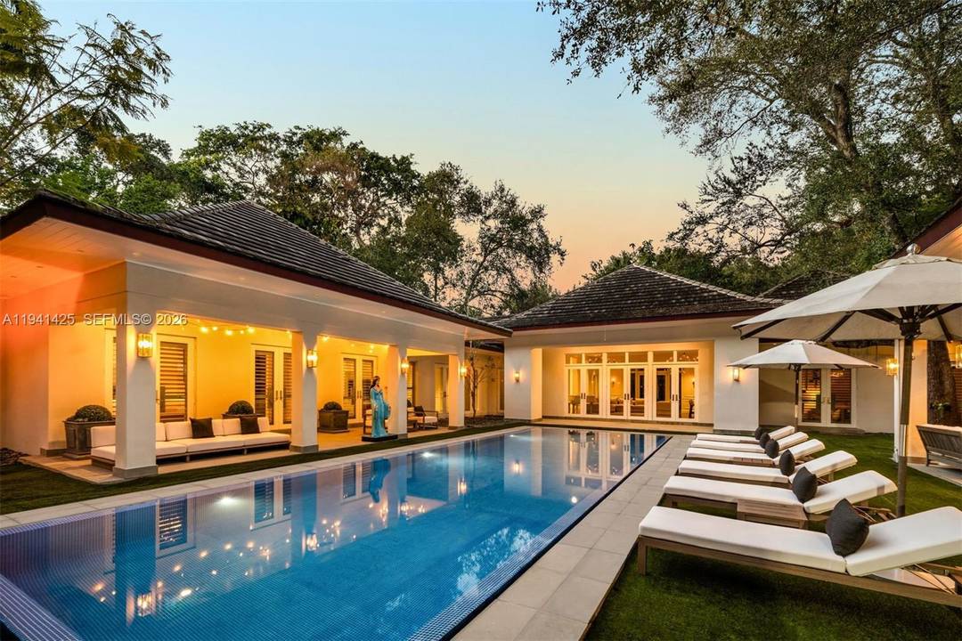 Set behind lush landscaping on approximately 1.