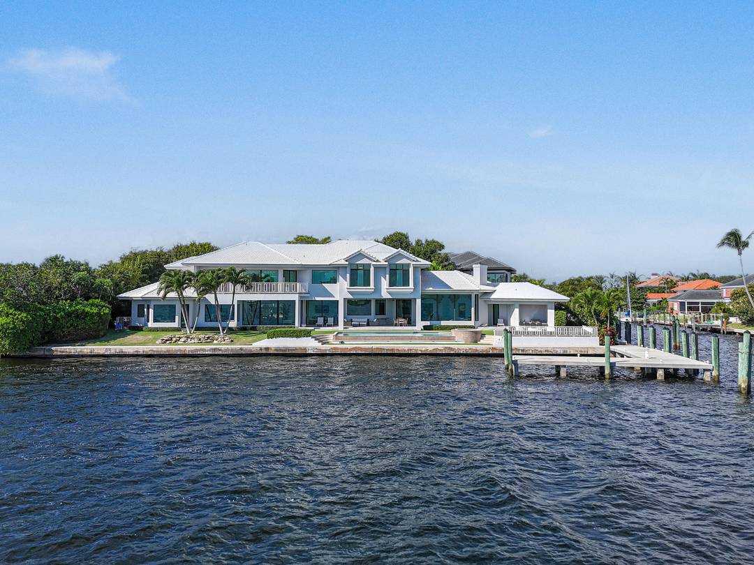 Experience the pinnacle of waterfront luxury with this exceptional estate, offering sweeping 180 panoramic views of MacArthur State Park, Munyon Island, and Singer Island.