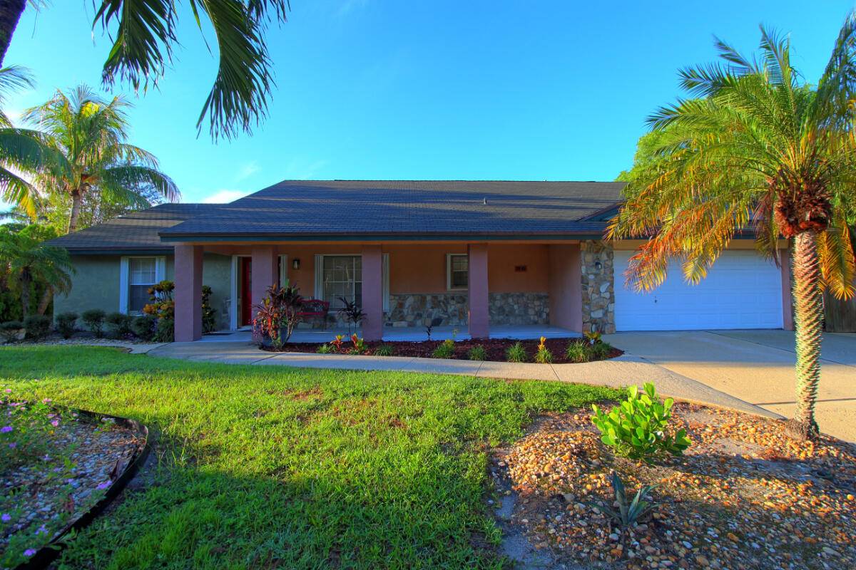 Welcome to your private retreat on a half acre of beautifully landscaped land with total privacy, lush gardens, and a sparkling pool just minutes from SR 7 441 and all ...