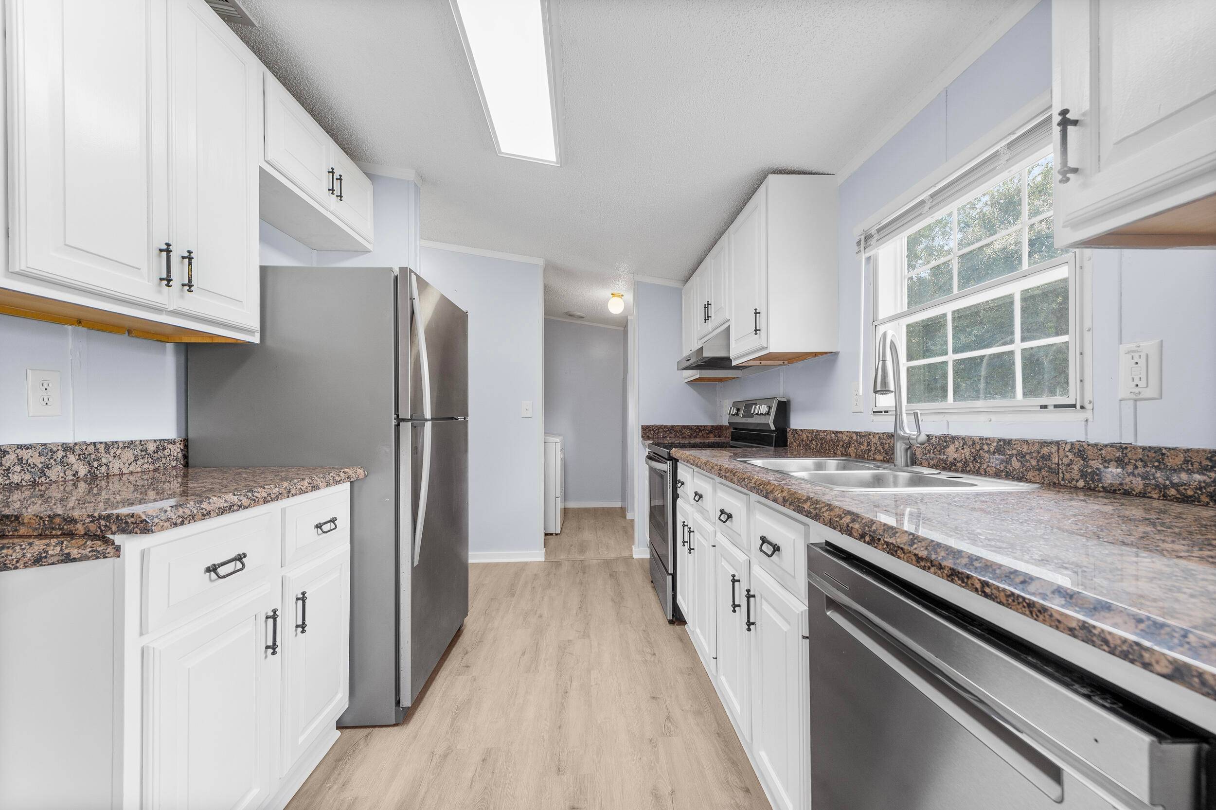 Set on more than half an acre in Palm City, this property offers both space and privacy with a fully fenced yard and a welcoming circular driveway.