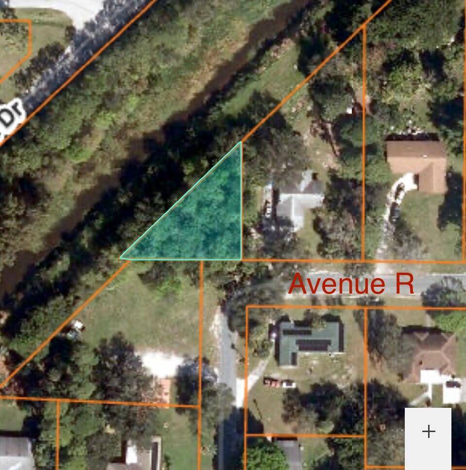 Build your dream home on this one of a kind triangular lot that backs up into a canal and cleared land on one side.