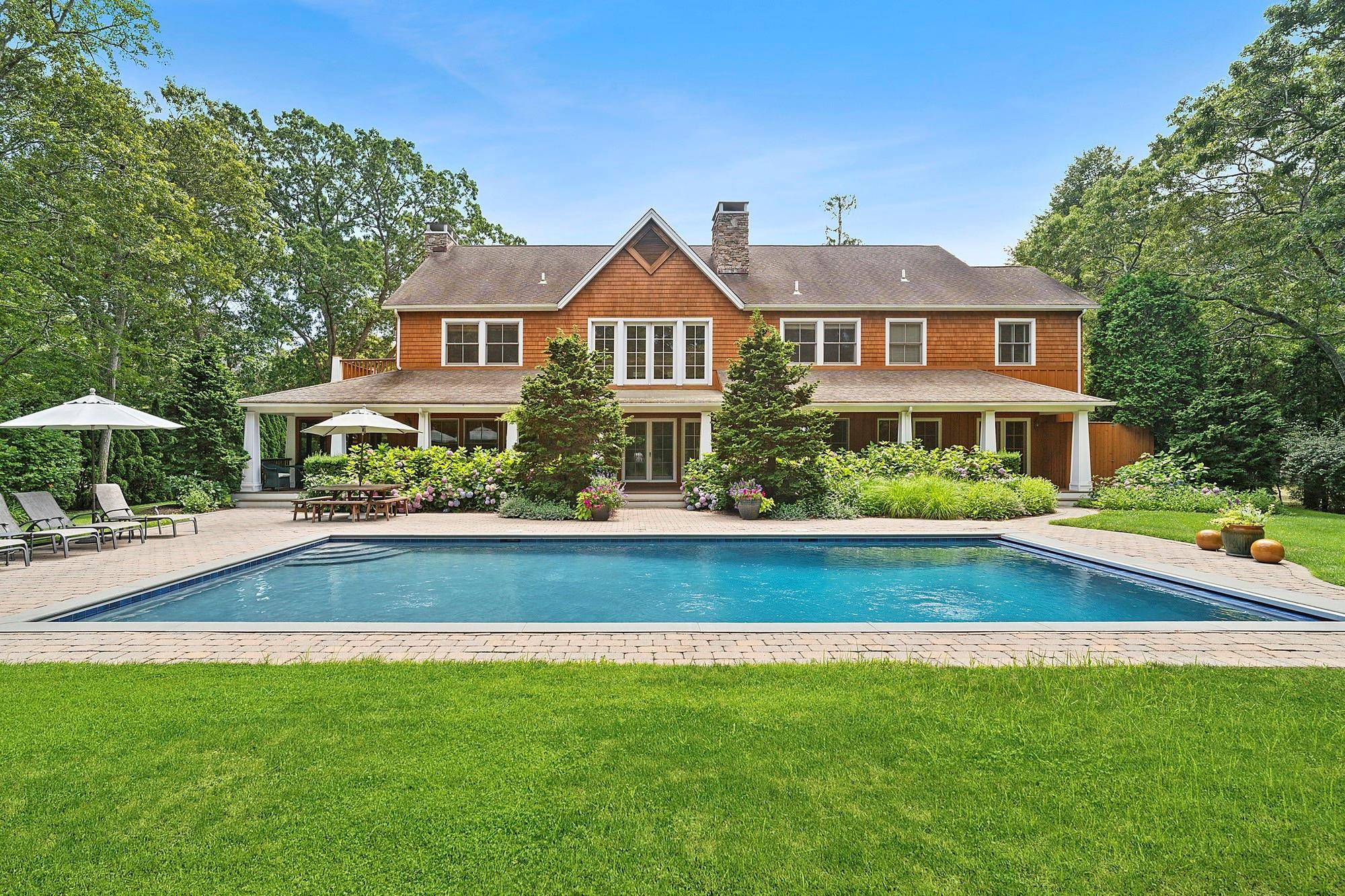 Nestled just two lots from Shinnecock Bay and less than a mile and a half from scenic Ponquogue Bridge, for quick access to Dune Road, this beautifully crafted custom home ...