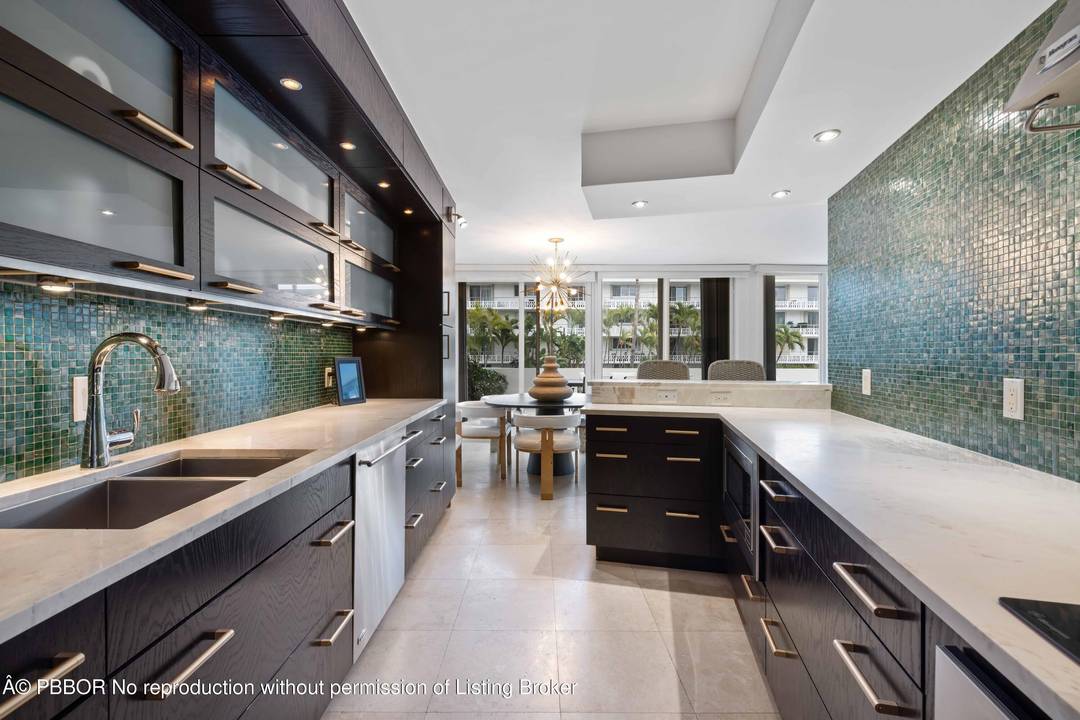 2BR 2. 5 BA turn key in town condo with deeded beach access and a rare expansive wraparound terrace overlooking Sunrise Ave.