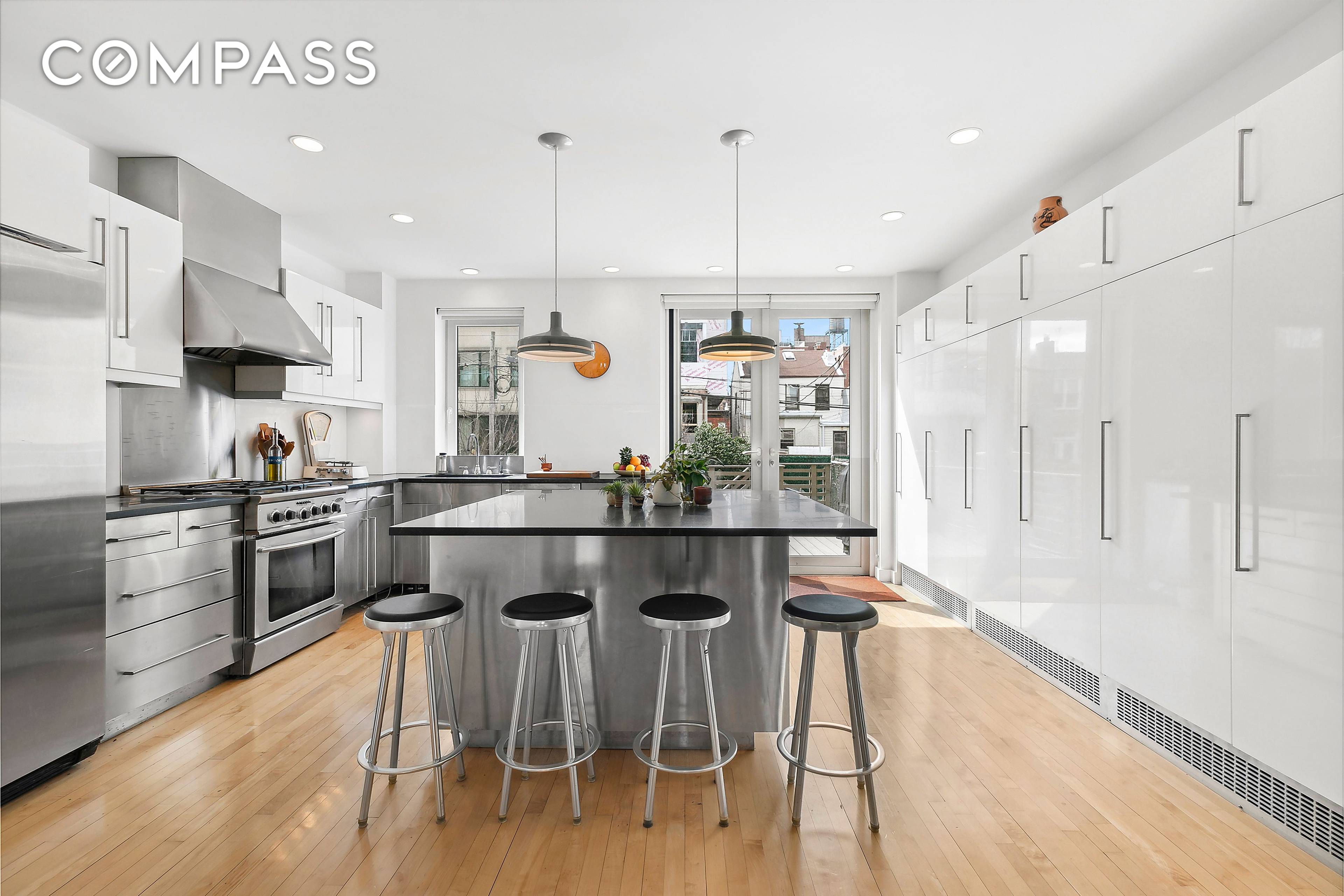 Contemporary Classic. Designed for comfort and easy living, this renovated 2 family townhouse features a beautiful and spacious 4 bedroom owner's duplex, over a charming one bedroom garden rental.