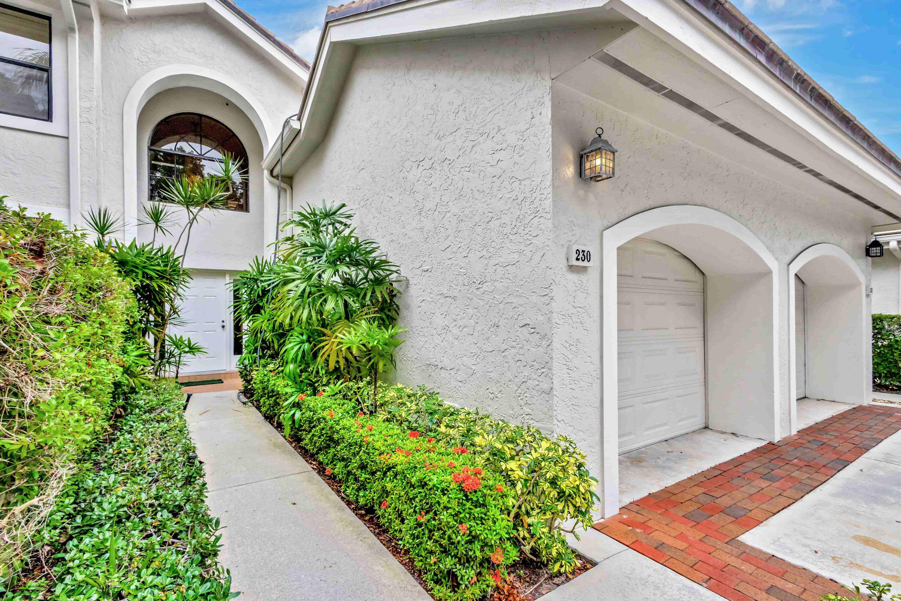 Enjoy tranquil water views lush gardens from this beautifully appointed home featuring a newly installed elevator, rich hardwood floors, plantation shutters vaulted ceilings.