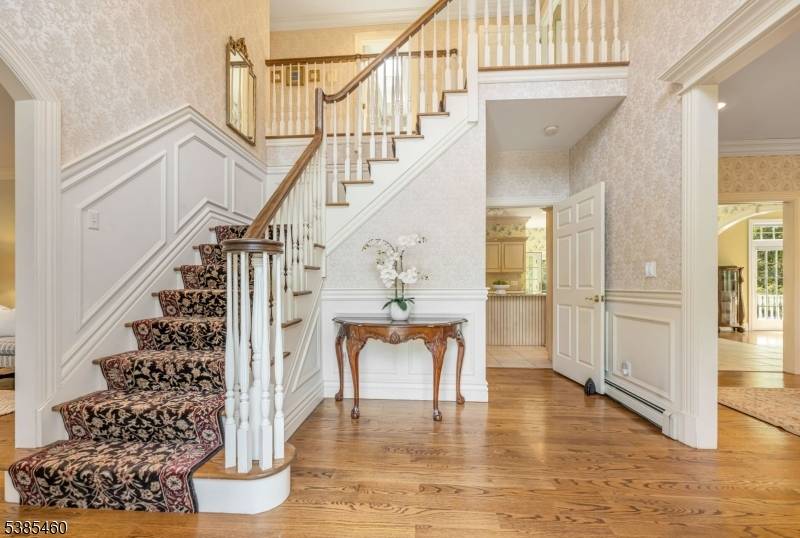 Set back from the street at the center of 3 private acres, this Franklin Lakes estate blends natural elegance with modern comfort.