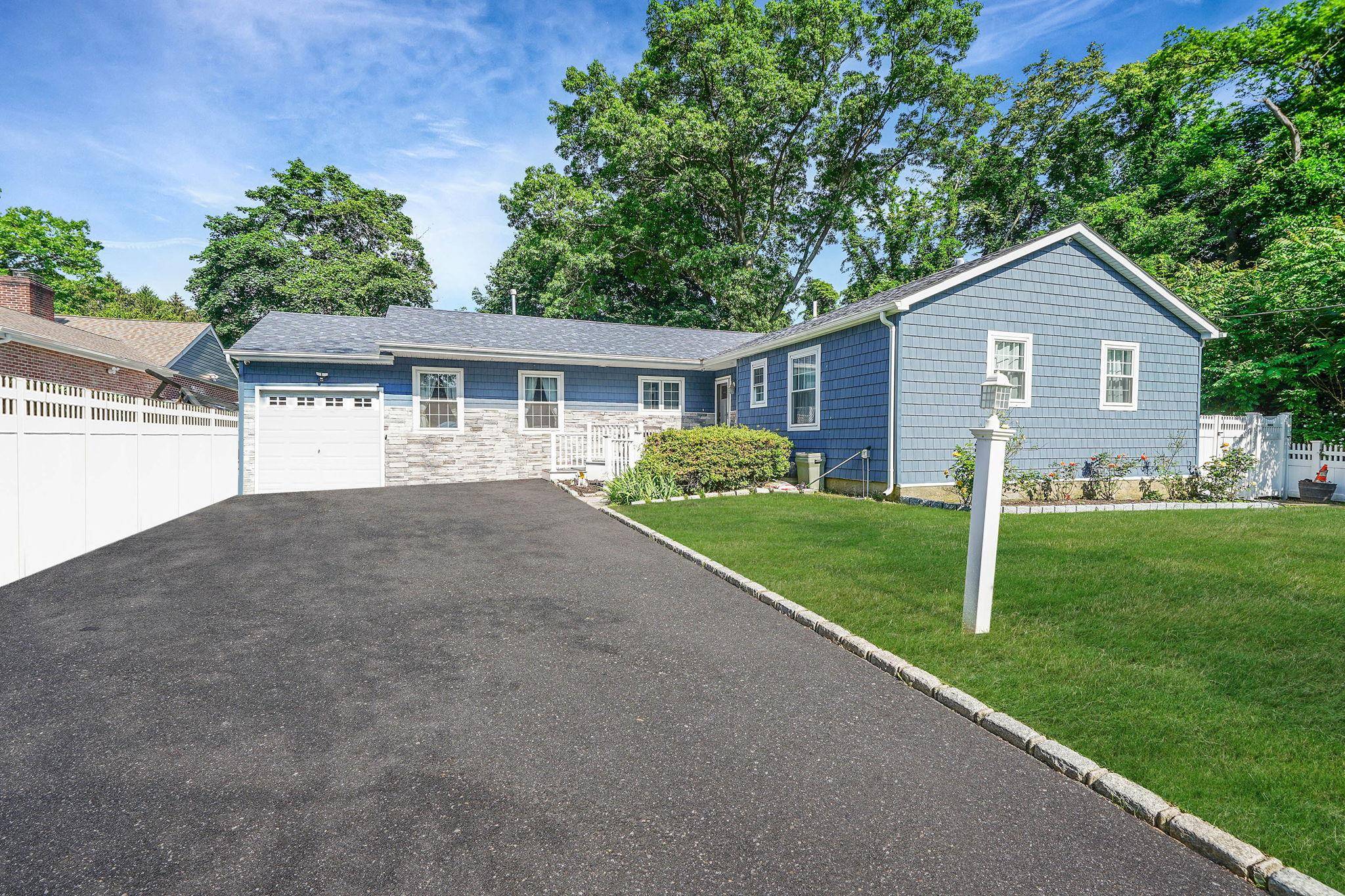 Welcome to 213 Pine Acres Blvd an impeccably renovated expanded ranch offering comfort, style, and functionality located within the Half Hollow Hills School District.