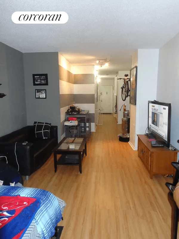 Doorman elevator building with a laundry facility on site at the end of the hallway.