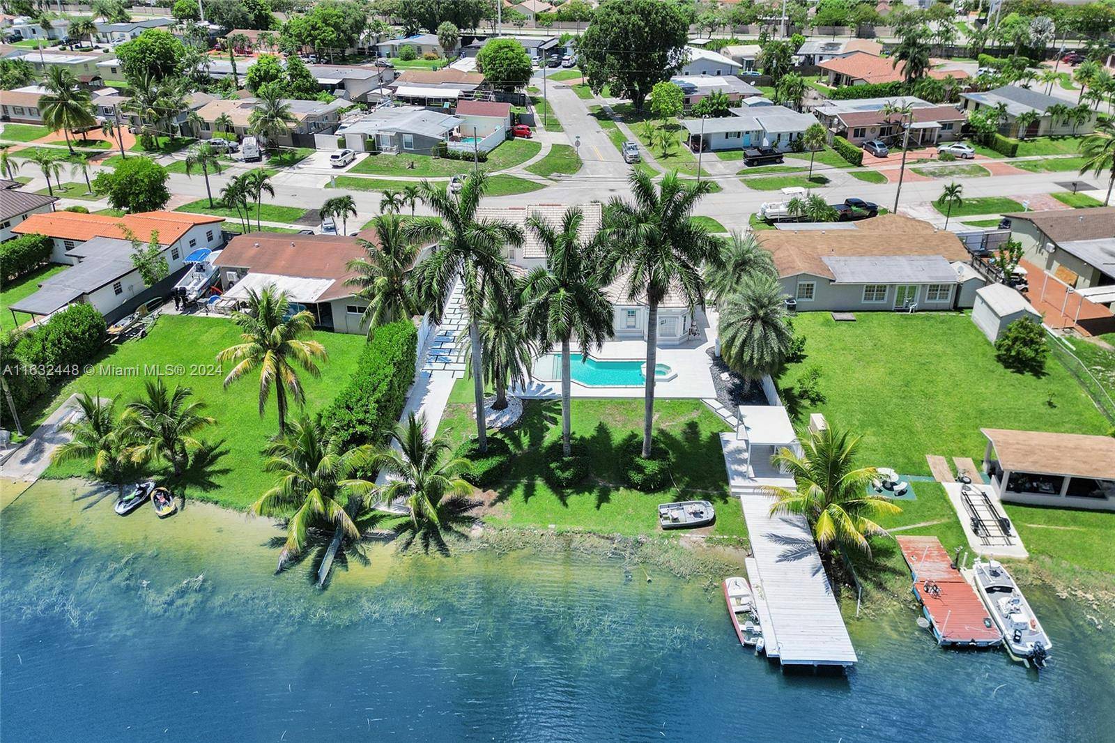 WELCOME TO your exquisite lakeside pool home, in Palm Springs North PSN, 5 BEDS, 4BATHS DEN on one of three interconnected lakes allowing motorized boats, fishing or swimming.
