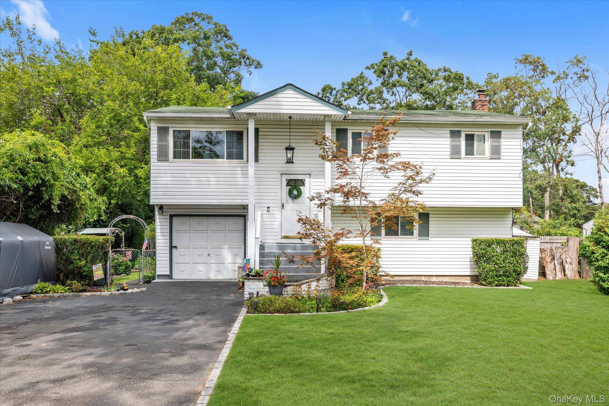 Welcome to this beautifully maintained Mother Daughter home, featuring two full kitchens, 4 bedrooms and 2 bathrooms, boasting a bright living room with solid hardwood floors and elegant crown molding.