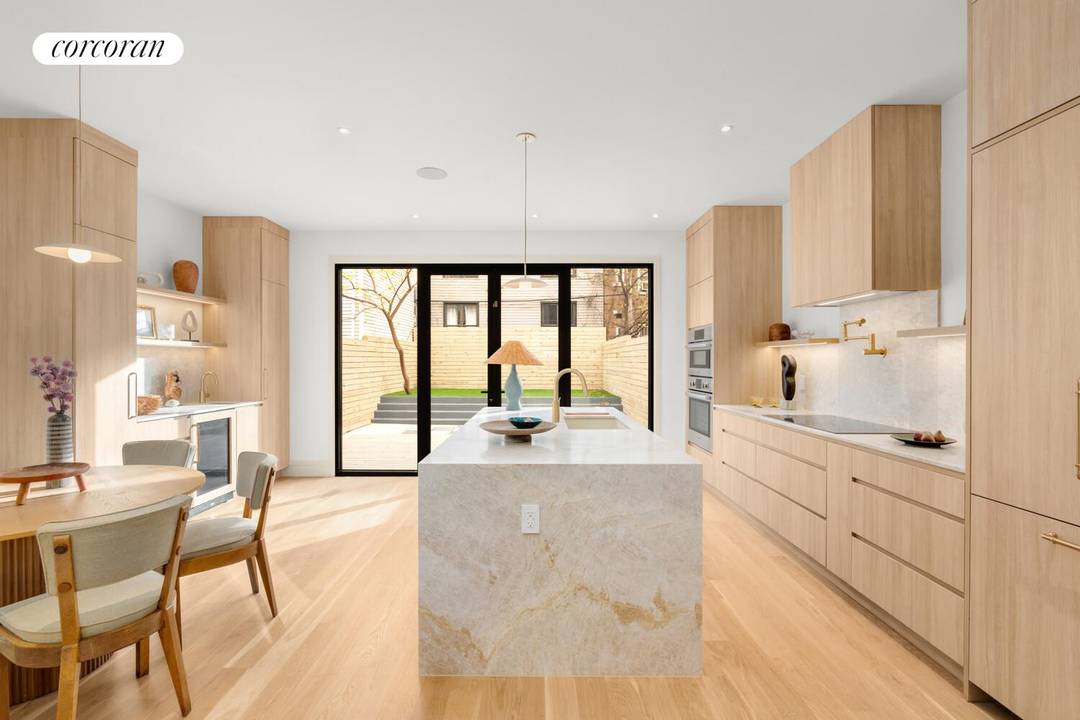 Tucked behind an olive green facade on a 25 foot wide lot, 980 Metropolitan Avenue is a fully reimagined fully detached single family townhouse where earthy materials and modern craftsmanship ...