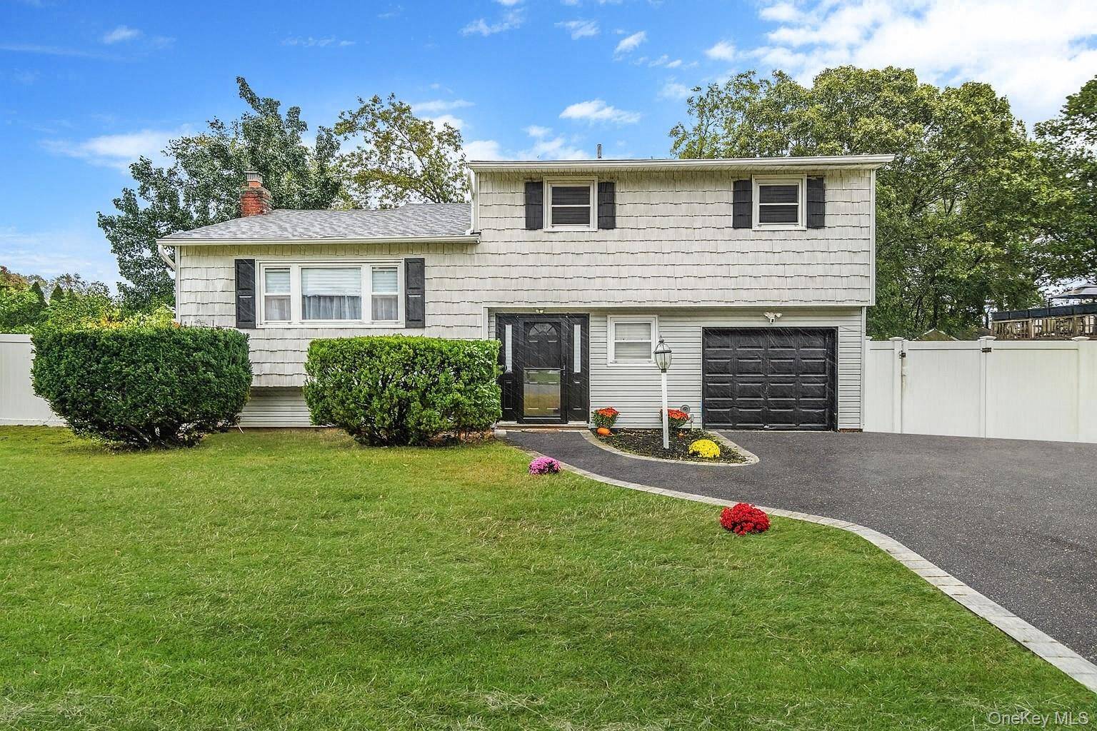 Bring your vision and a little imagination to this spacious split level home in the heart of Centereach !