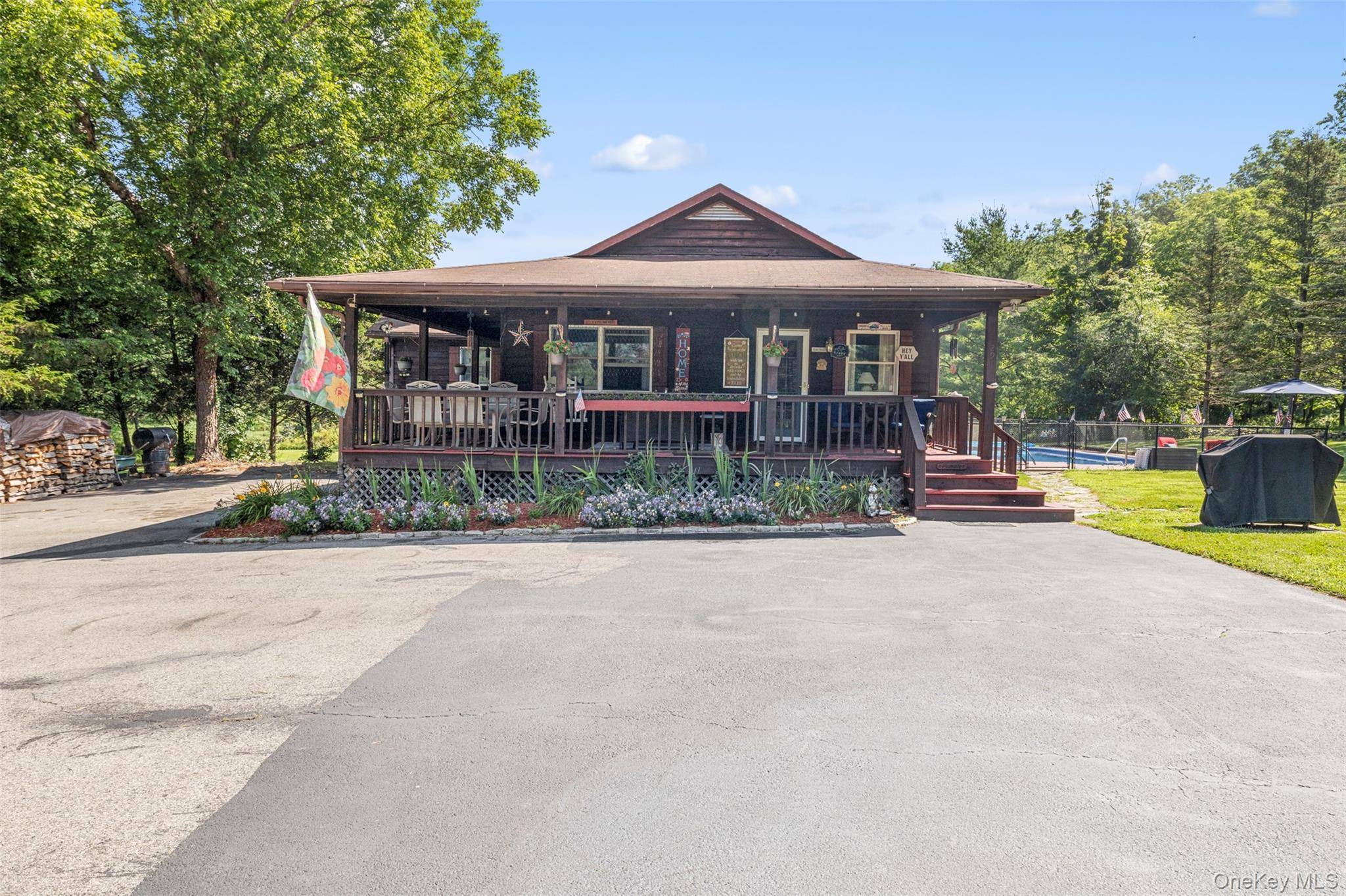 Welcome to this charming ranch style home featuring a wrap around rocking chair porch, an in ground pool, and a 1, 500 sq ft pole barn, all set on a ...