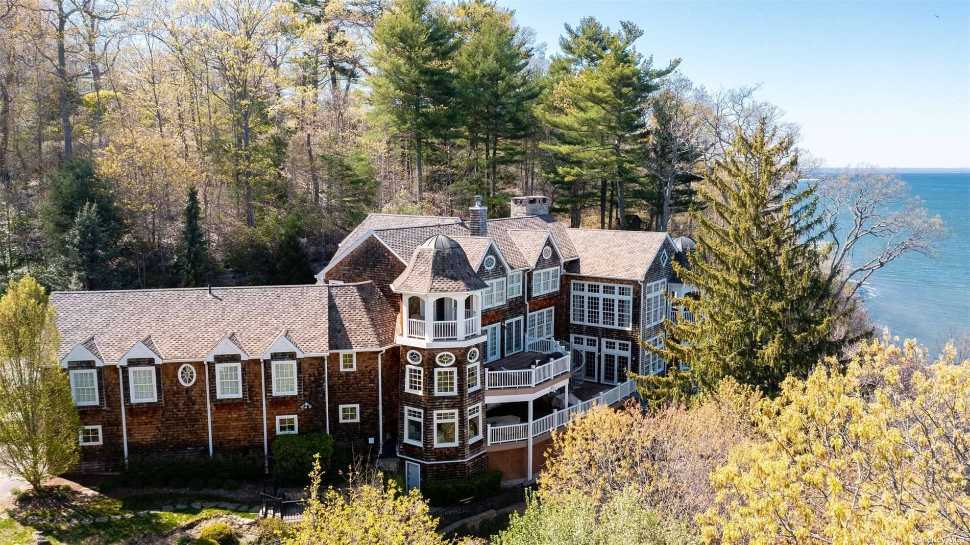 Hamptons style estate on Long Islands North Shore is an inspiring, secure, and dramatically designed WATERFRONT residence with multi level decks located in the Village of Laurel Hollow.