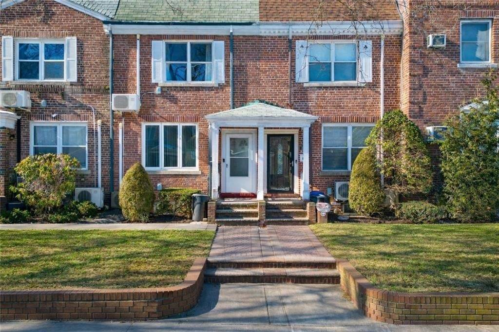Single family brick home in Bath Beach featuring two stories, a full finished basement, and a detached garage accessed via the community driveway.