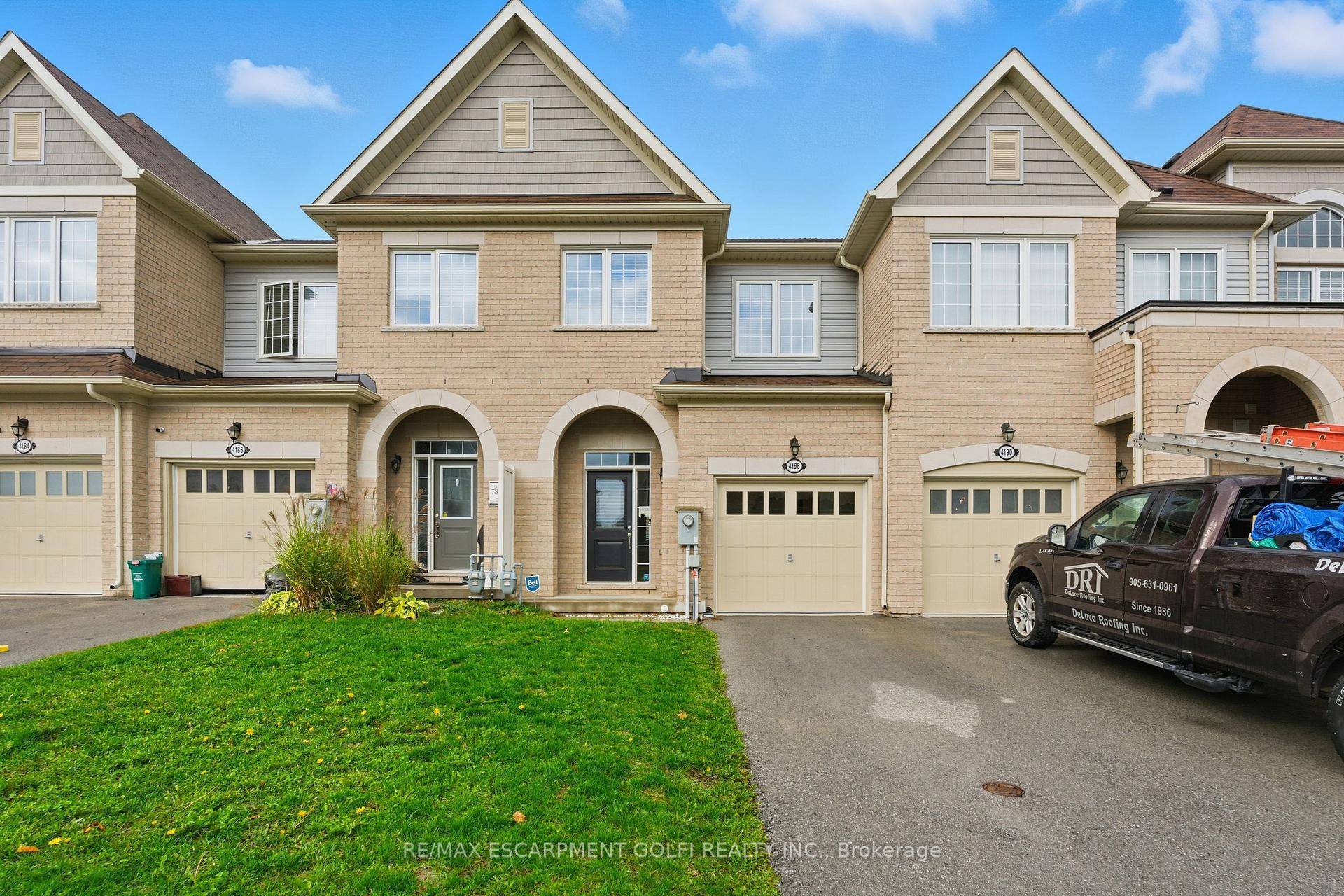 Modern 3 bedroom townhouse in Beamsville featuring an open concept main floor with a cozy gas fireplace and mounted TV in the living area.