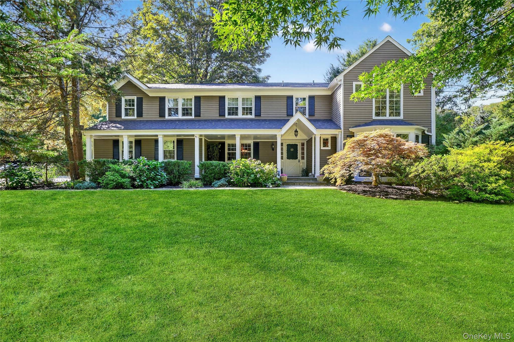 Welcome to 21 Mianus Drive a beautifully expanded colonial set on a picturesque property featuring a rustic barn conversion.