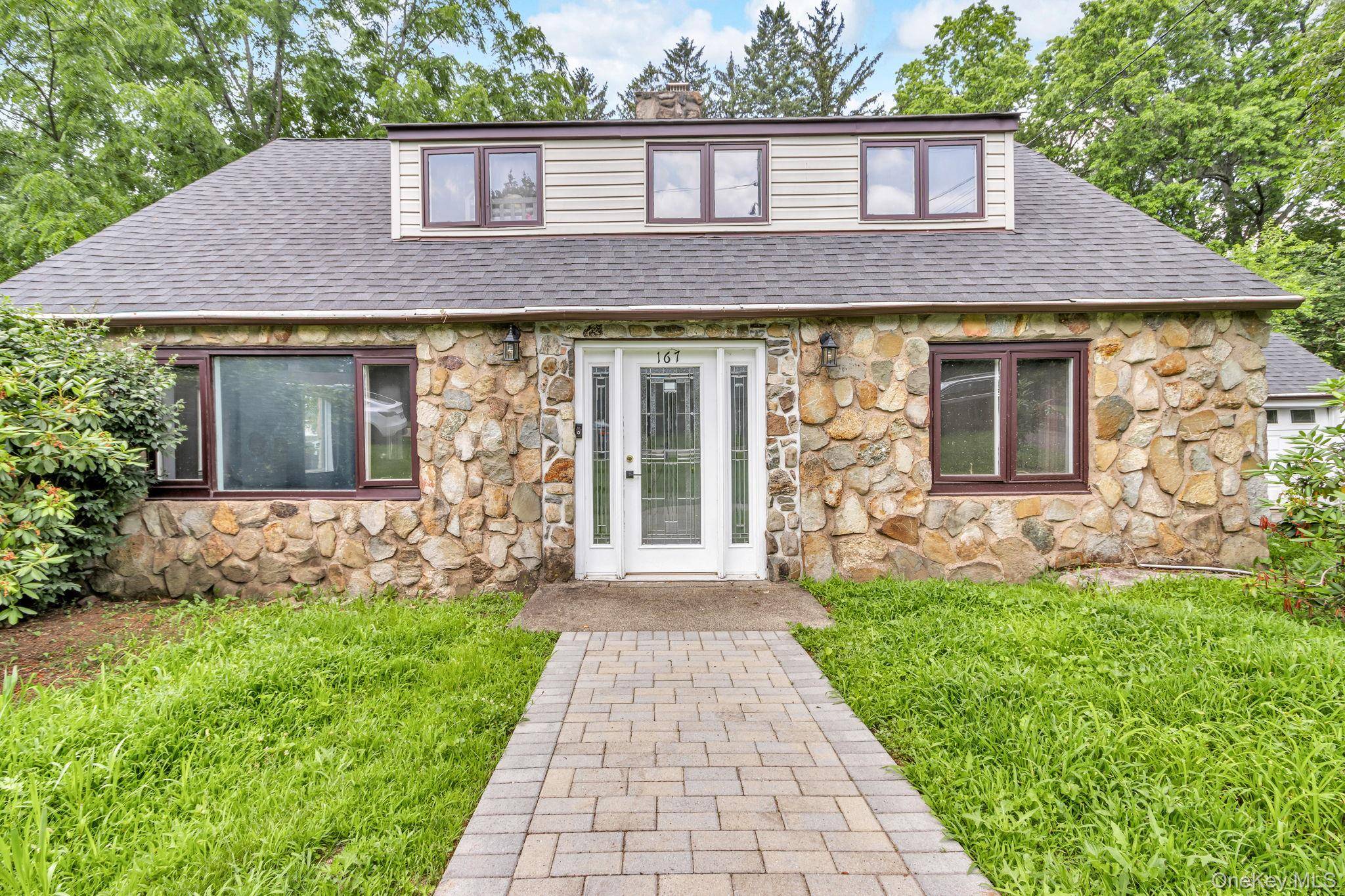 SUBURBAN PEACE AWAITS YOU in this large cape cod with updated kitchen, baths and more.