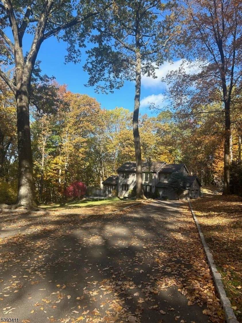 Nestled on a private, wooded lot, this beautiful custom home offers space, comfort and style throughout.