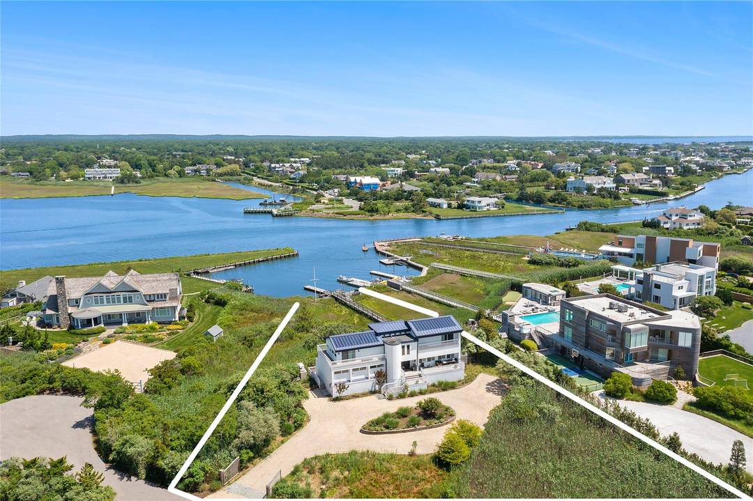 Located on a quiet street off Dune Road in prestigious Quogue, this distinctive four bedroom, four bath beach house offers an idyllic waterfront lifestyle.