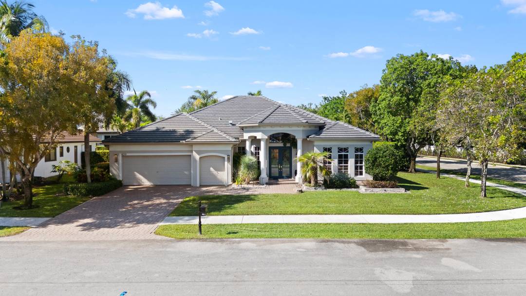Experience luxury living in this beautifully updated 4 bedroom, 4 bathroom, triple split home nestled in an exclusive Guard Gated Golf Course Community in the heart of Davie.