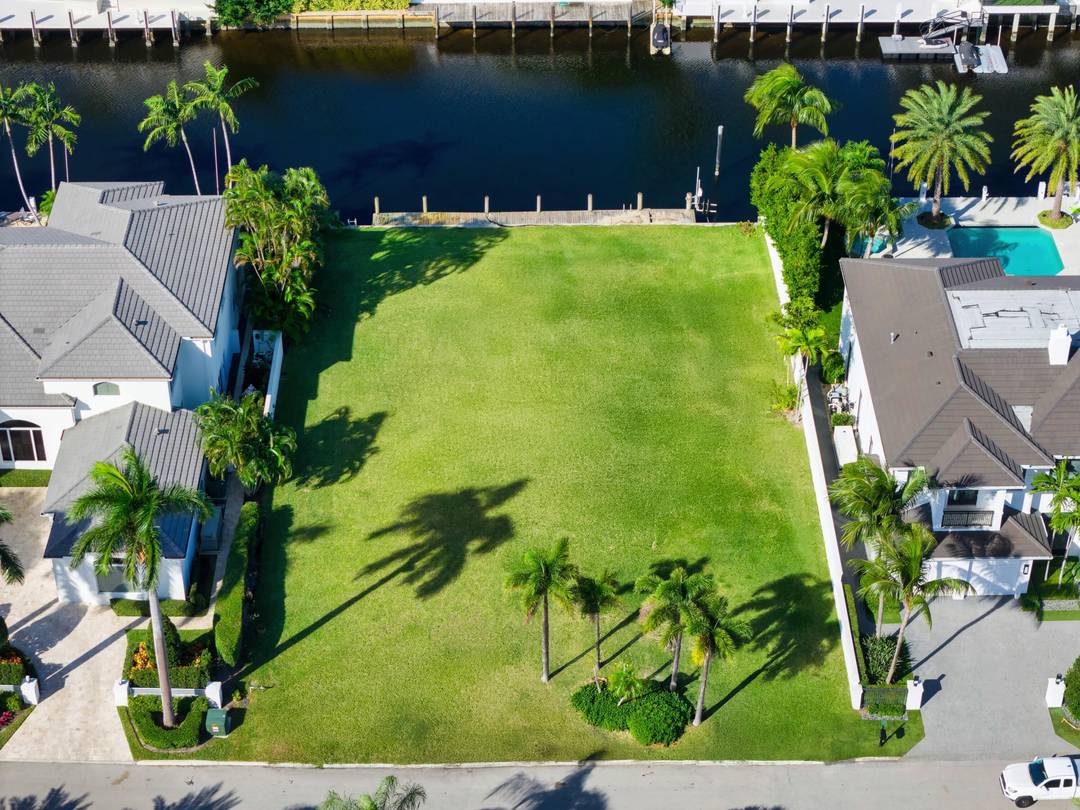 Remarkable Royal Palm Yacht CC waterfront vacant lot opportunity on prestigious and sought after East Alexander Palm Road sited on 97 ft of deepwater along the Buccaneer Palm Waterway with ...