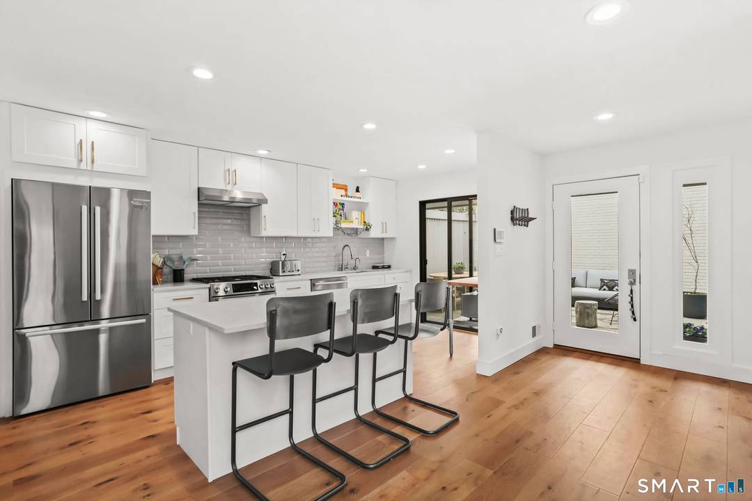 Tasteful turn key townhome with main level primary suite, open plan and two private outdoor areas to enjoy.