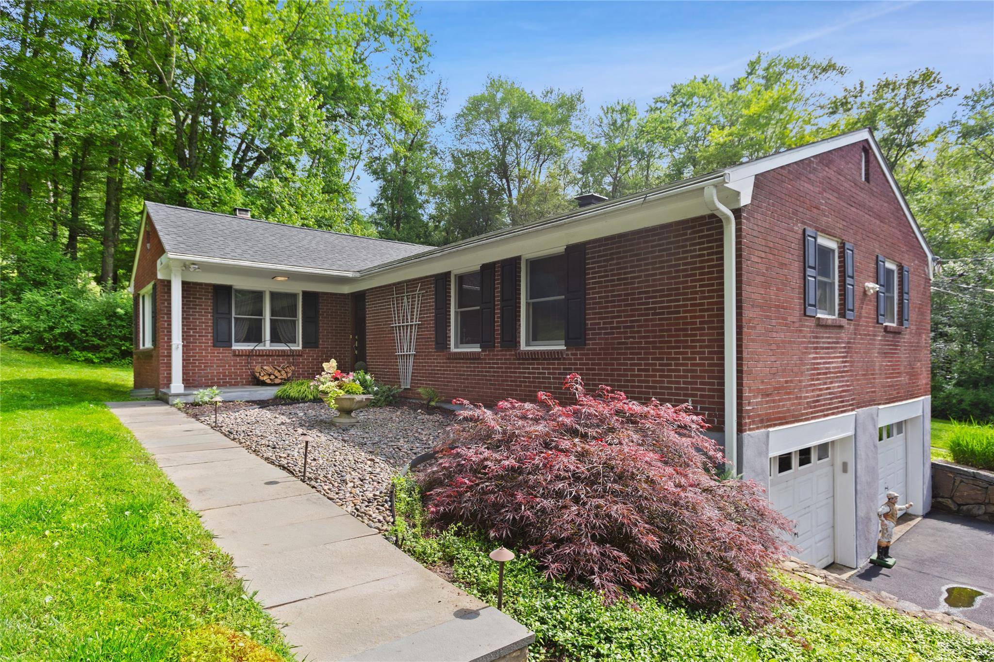 Welcome to this beautifully updated 3 bedroom, 2 bathroom brick ranch, nestled within a private lake community and set on nearly 3 acres of serene, landscaped grounds with mature plantings.
