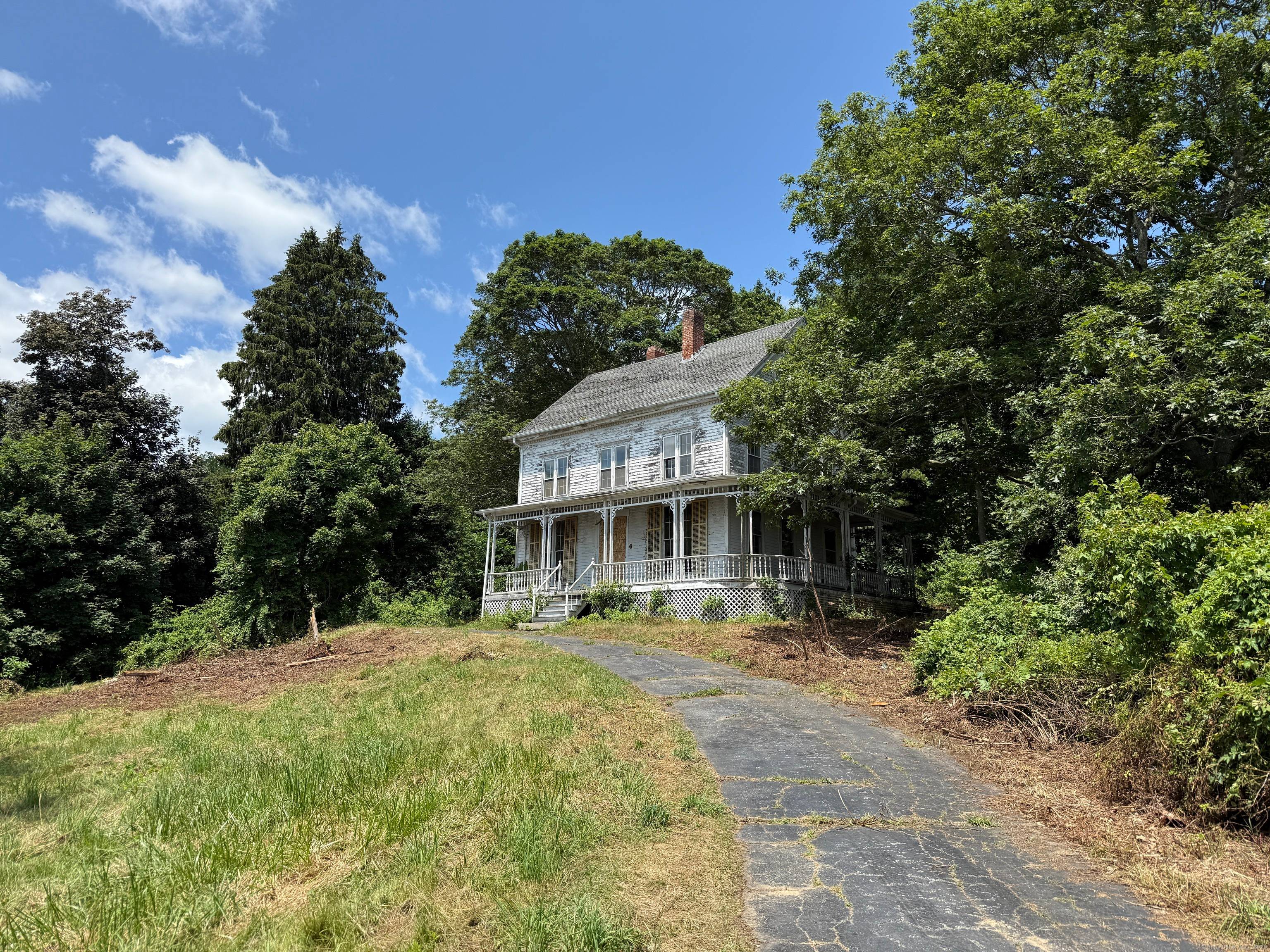 Stunning 1857 historic Victorian era home on a hilltop overlooking the Mystic River and the Mystic Seaport beyond.