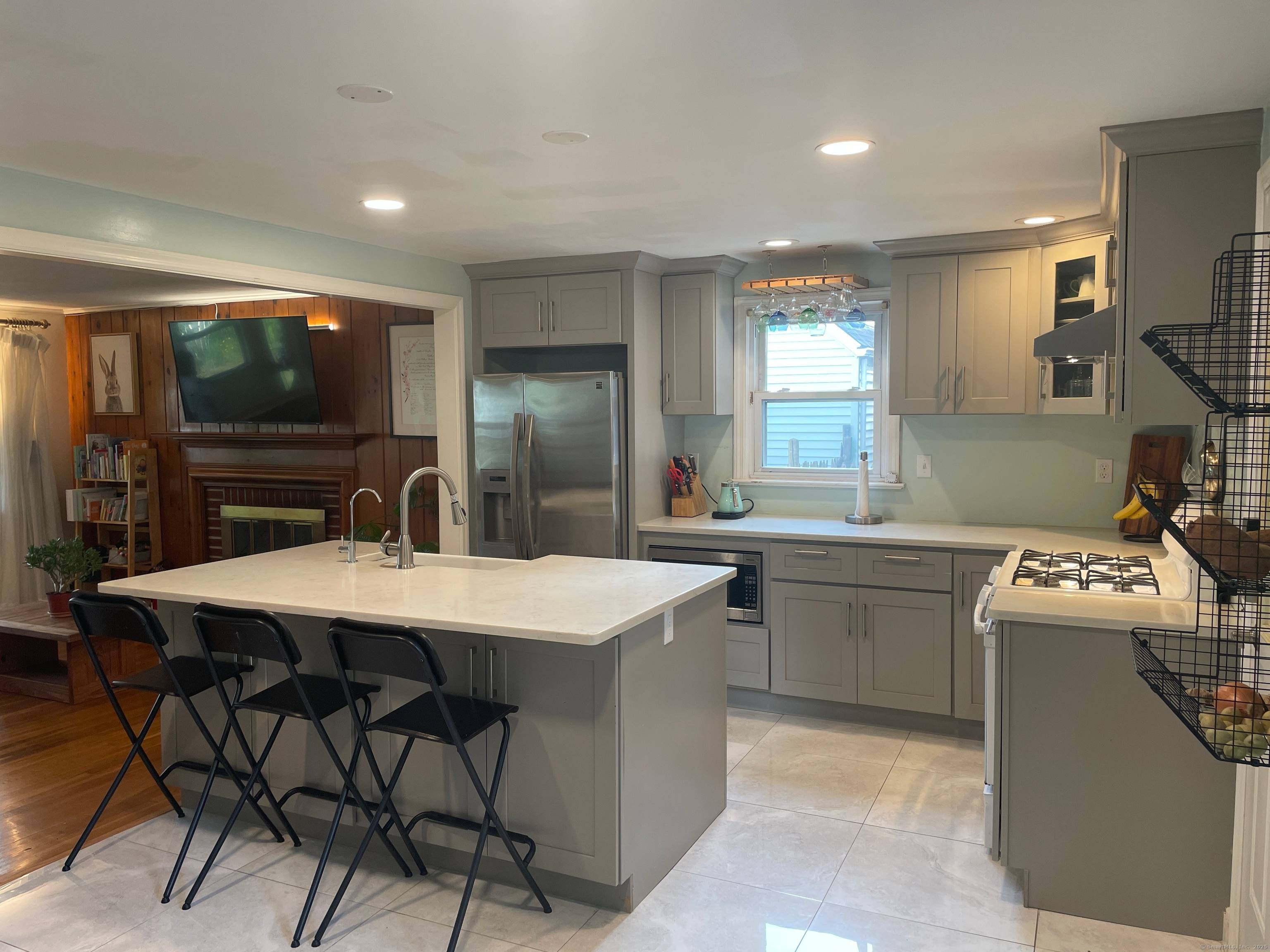 Recently updated with significant enhancements, this property offers main floor living featuring a new modern kitchen equipped with granite countertops, appliances, cabinets, and an island with seating.