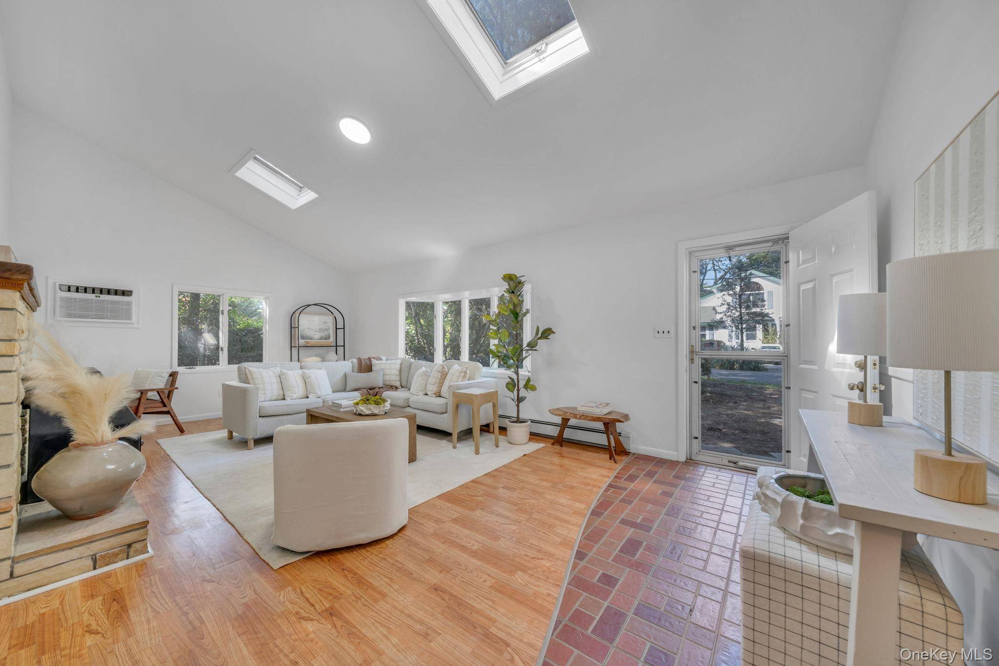 Spacious 3 Bedroom, 2 Bath Ranch featuring an eat in kitchen, living room with vaulted ceilings, skylights, and fireplace.