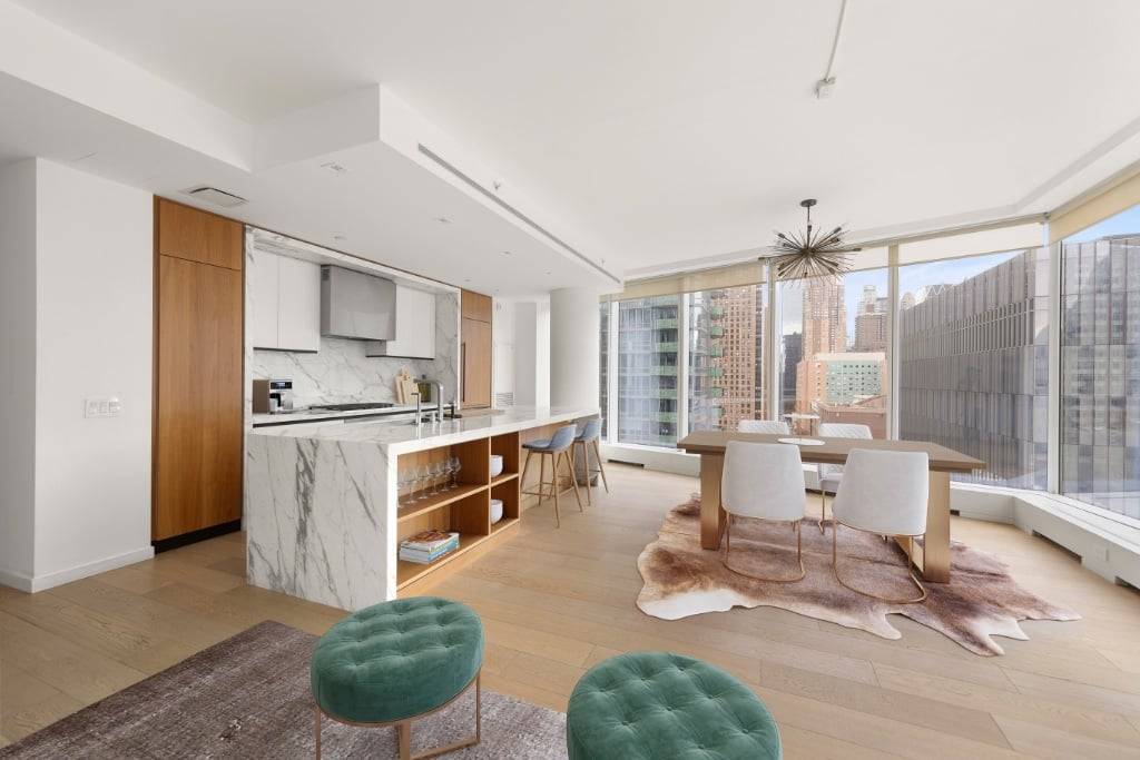 Nestled in a pristine corner, this two bedroom, two and a half bathroom apartment offers breathtaking views of the river and iconic midtown buildings.