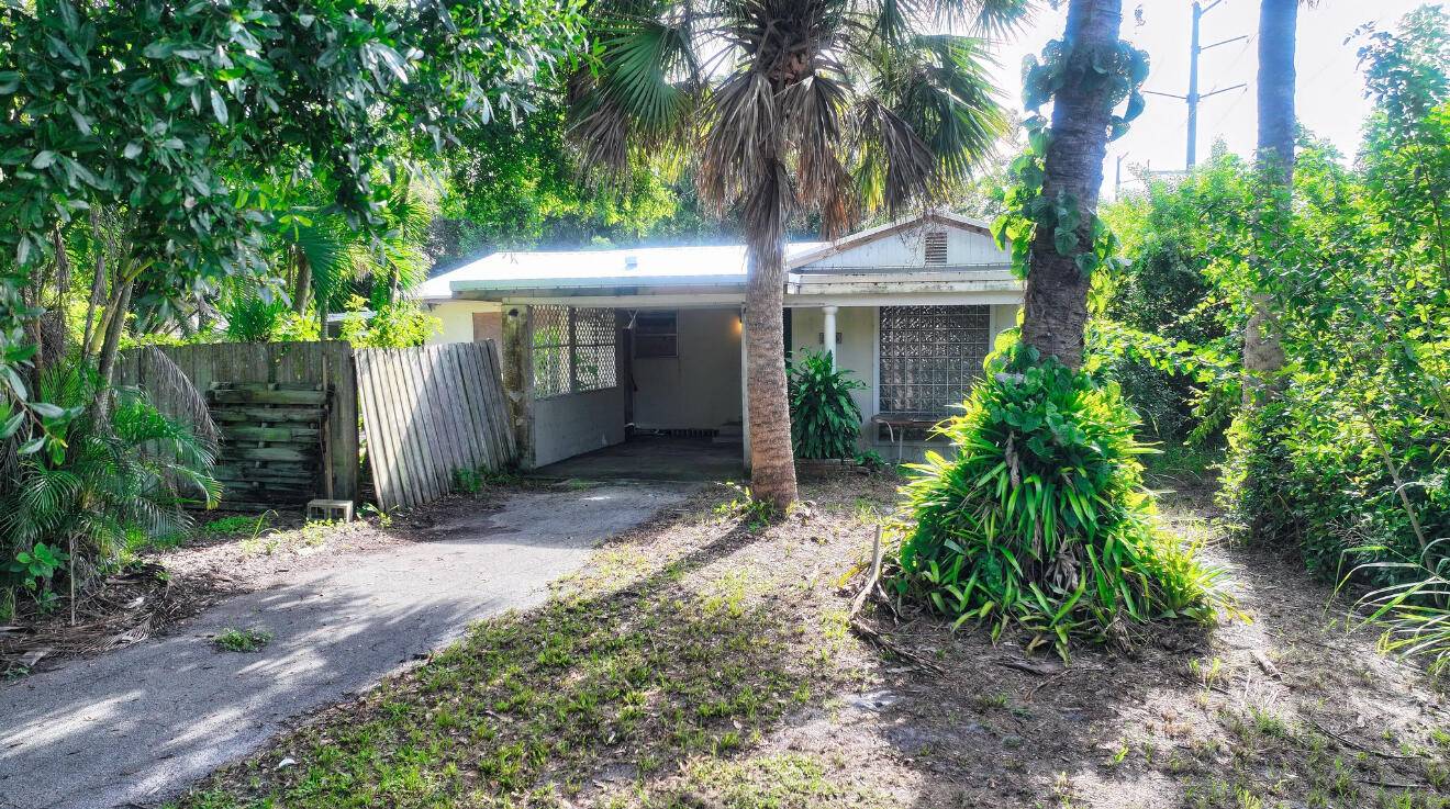 Handyman Special ! This 2 bedroom, 2 bath home sits on a half acre corner lot with a newer metal roof and small pool.