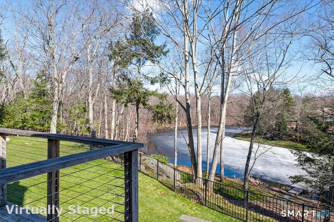 Lakefront living ! This elegant main home features 450 ft of private, pristine lakefront in a coveted area of North Stamford CT !